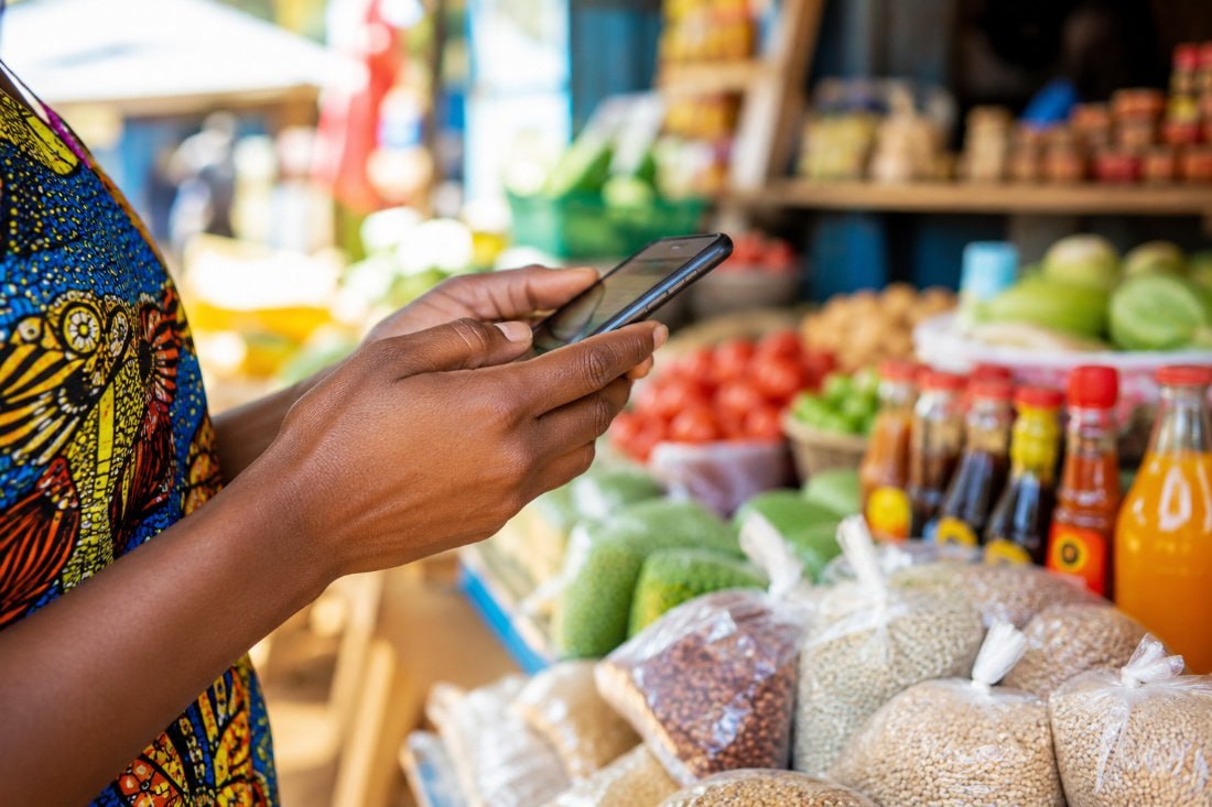 Market trader managing her business from a smartphone